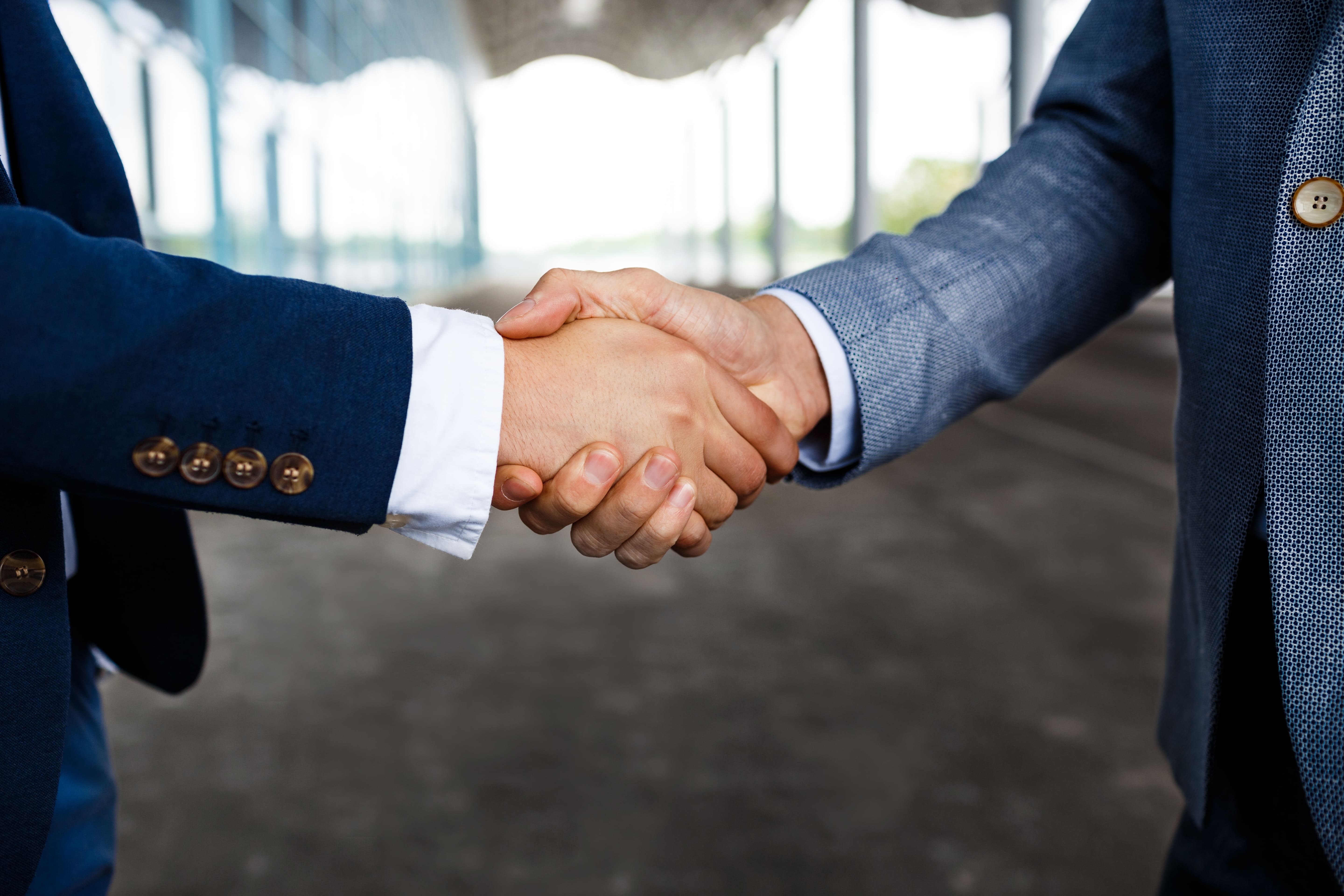 Two business partners shaking hands on a new collaboration.
